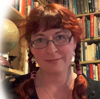 Profile picture of a female reviewer with red hair and glasses.